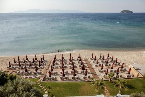 a group of umbrellas and chairs on a beach at Akti Hotel Kavala in Paleo Tsifliki