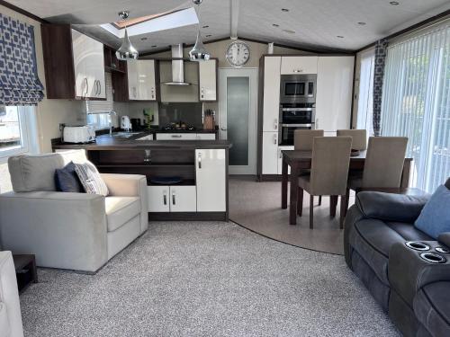 a kitchen and living room with a couch and a table at Drift Lodge in Tain