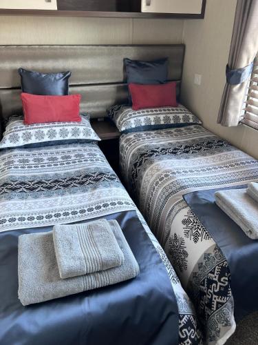 a group of three beds in a room at Drift Lodge in Tain