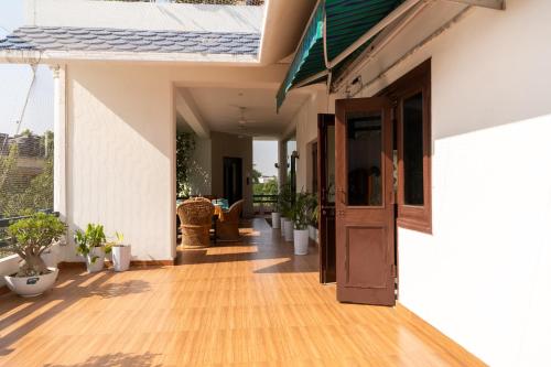 an open hallway of a house with a wooden floor at Girisadan Boutique Stay in Jaipur