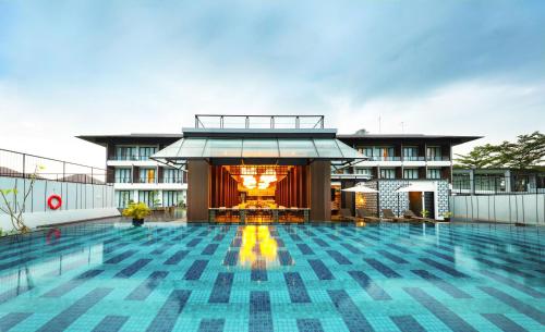 a swimming pool with a building in the background at Hotel Santika Premiere Garut in Garut