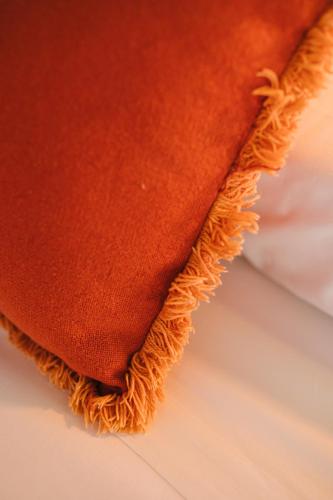 a close up view of an orange blanket at Curolla Petit Hotel in Maria de la Salut