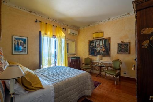 a bedroom with a bed and a desk at Casa ER&L in Porto Santo Stefano