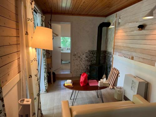 a living room with a table and a fireplace at Kitakaruizawa Morino Bessou NO8 in Tsumagoi