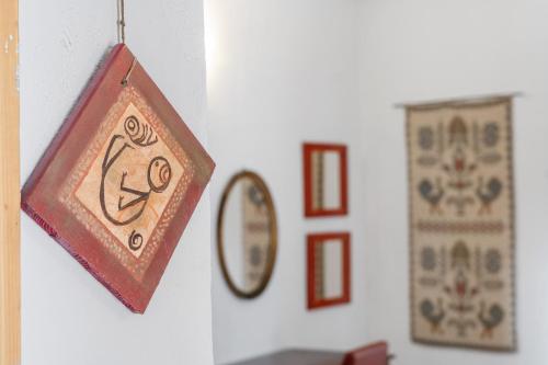 a clock hanging on a wall next to a mirror at Sa Funtana in Gonnesa