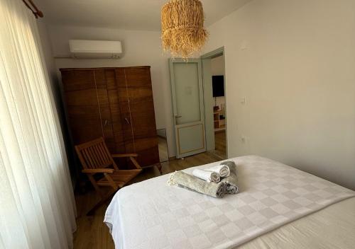 a bedroom with a bed with towels on it at Urla The Orange House in Kuscular