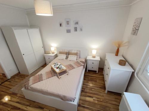 a bedroom with two beds and two night stands at Harmony Suite Apartment in Pápa