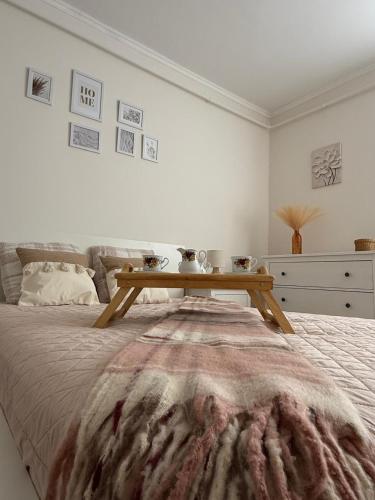 a bedroom with a bed with a wooden table on it at Harmony Suite Apartment in Pápa