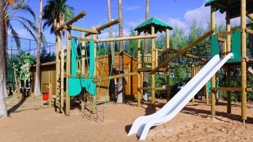 a playground with a slide in the sand at Servatur Waikiki in Playa del Ingles