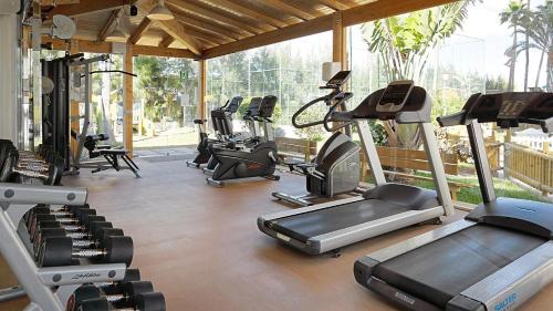 a gym with a bunch of treadmills and exercise bikes at Servatur Waikiki in Playa del Ingles