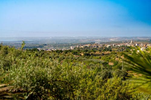 a view of a city from the top of a hill at Collemeti - Country House in Noto