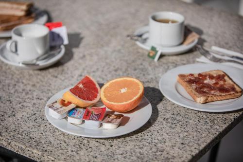 a table with two plates of food and a cup of coffee at Servatur Waikiki in Playa del Ingles
