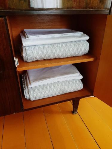 three folded towels on a shelf in a cabinet at Tapan in Berd