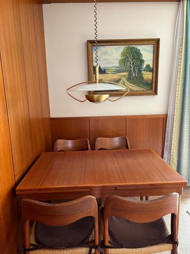 a dining room with a wooden table and chairs at Villa Paradise in Neudörfl