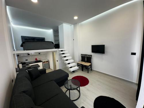 a living room with a couch and a bed at Vila Calm in Pogradec