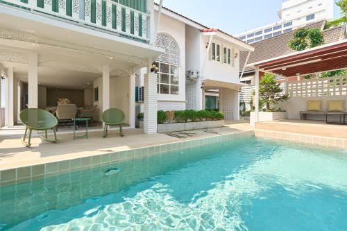 a house with a swimming pool in front of a house at Luxury Pool Villa in the Heart of the Chiang Mai in Chiang Mai