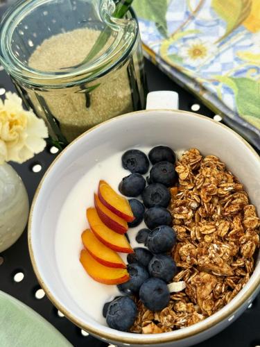 a bowl of granola with blueberries and peaches at Casa Canem in Badacsonytomaj