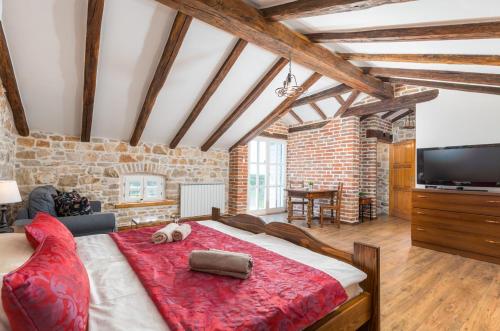 a bedroom with a large bed with a red blanket at Villa Lamija by Villsy in Krmenjak
