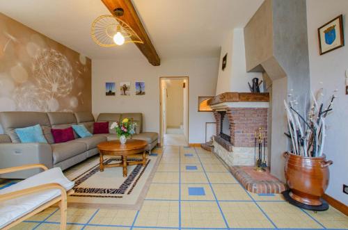 a living room with a couch and a fireplace at Le four de mimile in Montieramey