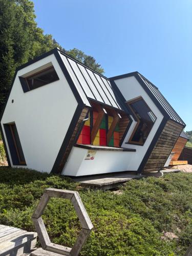 a house that is sitting on top of the grass at Apartments Beeland Skok in Mozirje