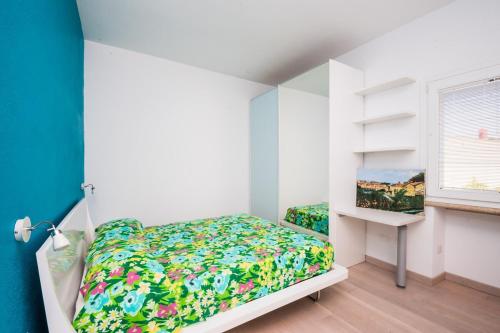 a small bedroom with a bed and a window at Villa Ginevra- Private Pool in Orosei