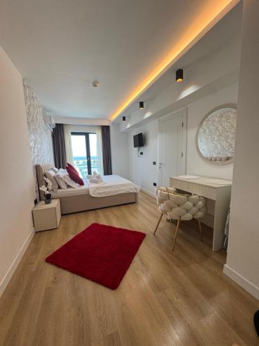 a bedroom with a bed and a desk and a red rug at AmyMamaia marina blue in Mamaia