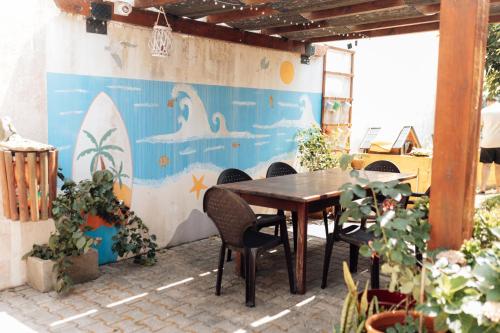 a patio with a table and chairs and a wall at Casa da Avó Bela in Buarcos