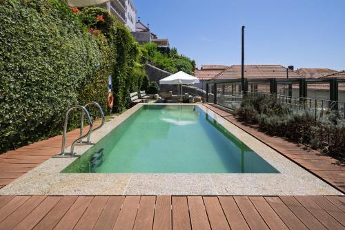 a swimming pool in the middle of a house at Porta Nobre Boutique Hotel by Aspasios in Porto