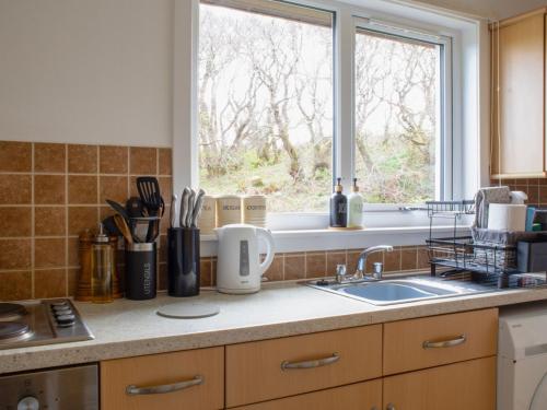 a kitchen counter with a sink and a window at Holiday Home Alan's House by Interhome in Staffin