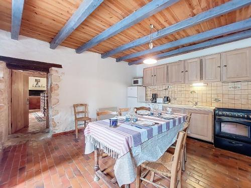 a kitchen with a table and chairs in a room at Holiday Home Petichaud by Interhome in Saint-Sulpice-dʼArnoult