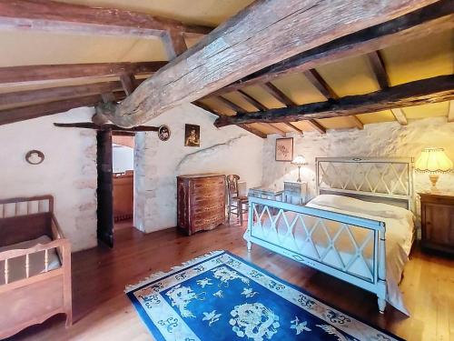 an attic bedroom with a bed and a table at Holiday Home Petichaud by Interhome in Saint-Sulpice-dʼArnoult