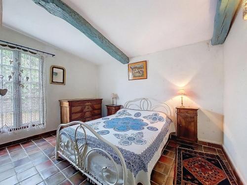 a bedroom with a white bed and a window at Holiday Home Petichaud by Interhome in Saint-Sulpice-dʼArnoult