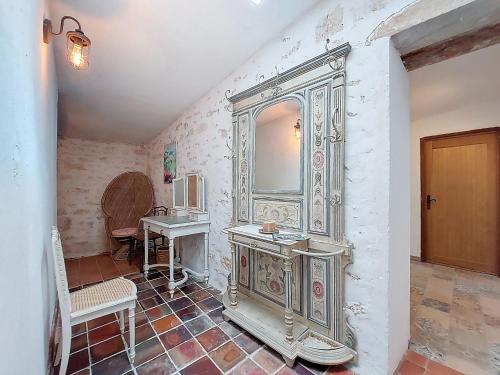 a bathroom with a large mirror and a sink at Holiday Home Petichaud by Interhome in Saint-Sulpice-dʼArnoult