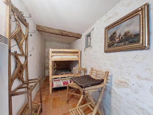 a room with a painting on the wall and a table and ladder at Holiday Home Petichaud by Interhome in Saint-Sulpice-dʼArnoult