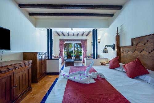 a bedroom with a large bed with a baby laying on it at Grand Makadi - Couples and Families Only in Hurghada