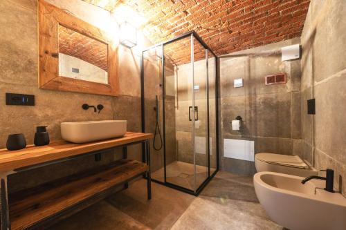 a bathroom with a shower and a sink and a toilet at Ca d' Vetu in Roccaforte Mondovì