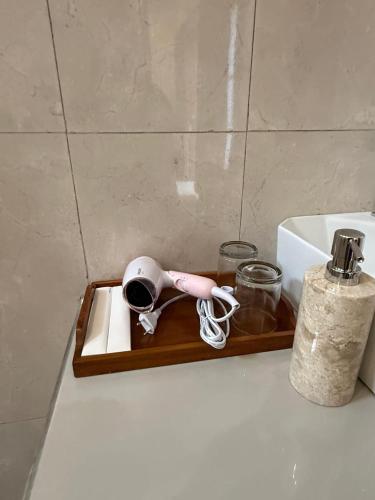 a wooden tray with a hair dryer and a sink at D'vayana Nusa Hotel in Nusa Penida