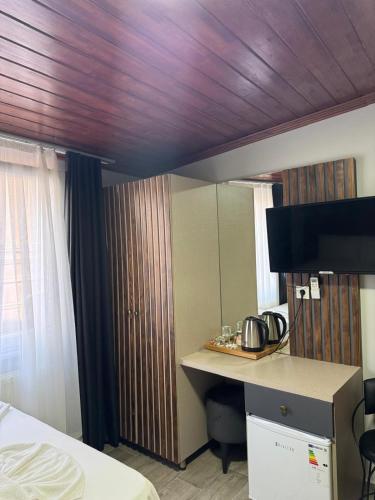 a room with a bed and a desk with a mirror at Nook Boutique in Istanbul