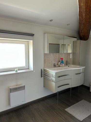 a bathroom with a sink and a window at Bel Appartement au 2 eme in Aix-en-Provence