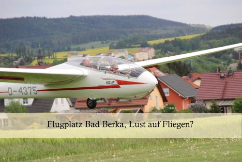 a small airplane sitting on top of a field at Ferienwohnung Auszeit am Kurpark Bad Berka # Balkon # ruhige Lage # gratis Parkplatz & WLAN # Nähe Weimar # Weimarer Land in Bad Berka
