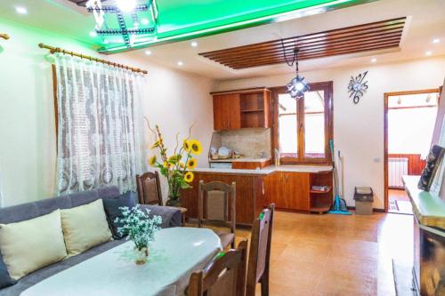 a living room and kitchen with a table and a couch at Cozy Villa Retreat in Cigov Chark in Tsigov Chark