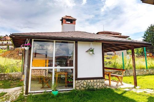 a small house with a gazebo at Cozy Villa Retreat in Cigov Chark in Tsigov Chark
