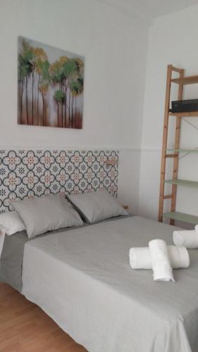 a bedroom with a large bed with two pillows at La Casita de Mari in Estepona