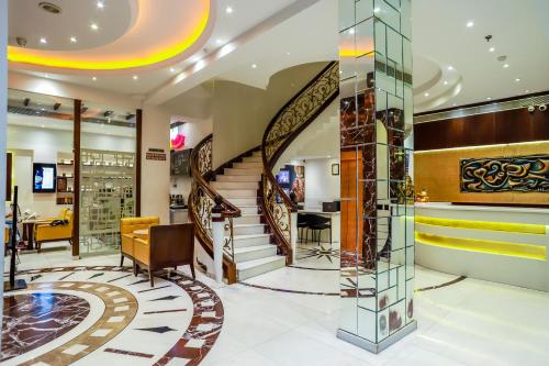 a lobby of a store with a spiral staircase at Hotel Grand Godwin - Free Airport Pick-Up in New Delhi