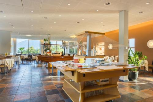 a restaurant with tables with food on it at Bellavista Swiss Quality Hotel in Vira