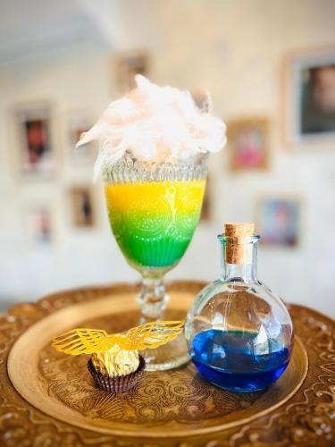 a drink and a bottle on a wooden table at Harry Potter Magic House in Senec