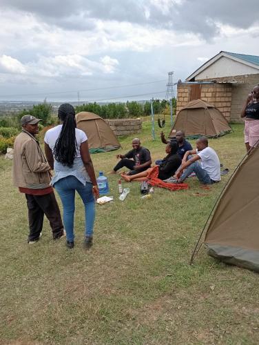 a group of people in a field with tents at Longonot View Camp and Accommodation, Naivasha in Naivasha
