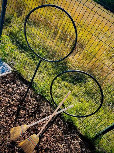 two tennis rackets sitting on the ground next to a net at Harry Potter Magic House in Senec