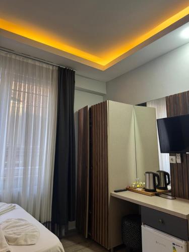 a hotel room with a bed and a desk and a window at Nook Boutique in Istanbul