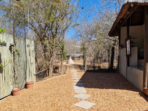 a walkway leading into a yard with a fence at The Dreamcatcher Lodge in Hoedspruit